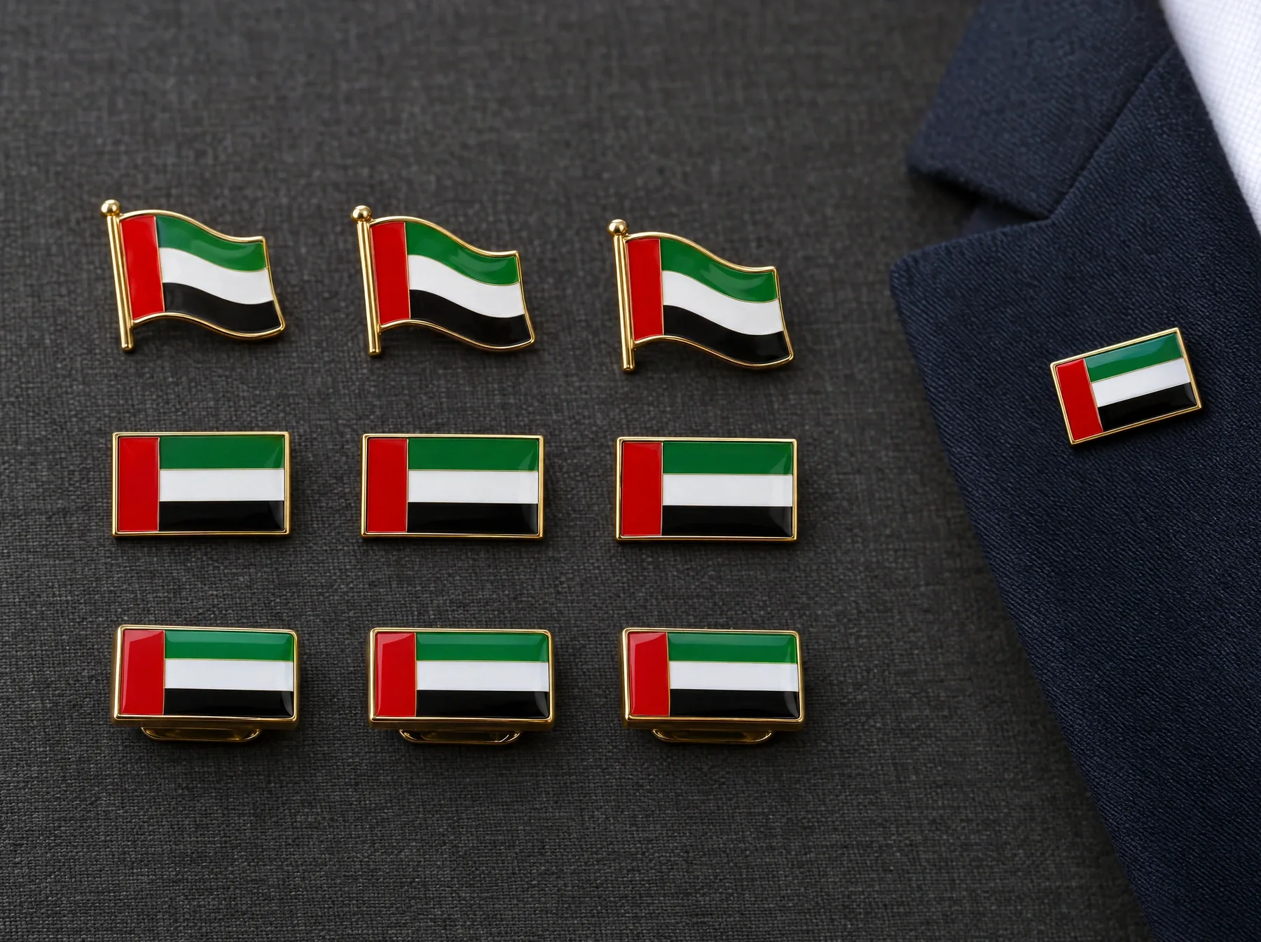 Enamel UAE flag lapel pins and magnetic badges, one worn on the lapel of a navy suit